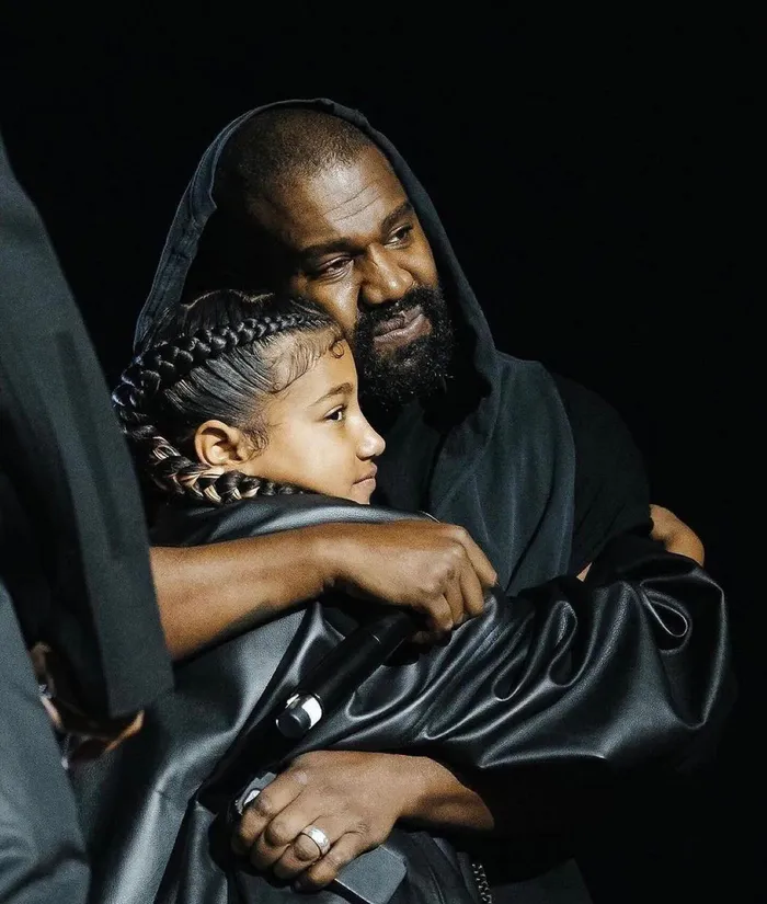 North West poses with father Kanye West; she reveals he and Kim drew the line at a nose bridge piercing.
