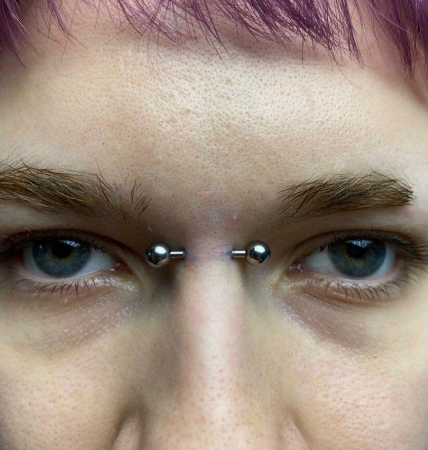 A bridge piercing is a type of nose piercing placed horizontally across the upper part of the nose, between the eyes.
